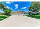 Charming exterior features a well-manicured lawn, lush landscaping, and a spacious three car garage at 208 147Th Ne St, Bradenton, FL 34212