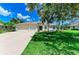 Well-manicured lawn leads to a charming home with a spacious driveway and three-car garage at 208 147Th Ne St, Bradenton, FL 34212