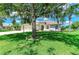 Inviting curb appeal with lush lawn and mature trees in front of home with a three car garage at 208 147Th Ne St, Bradenton, FL 34212