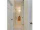 Hallway featuring neutral-colored walls, tile flooring, and multiple rooms at 208 147Th Ne St, Bradenton, FL 34212