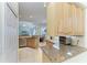 Well-equipped kitchen with stainless steel appliances, granite countertops, and ample cabinetry, creating an efficient workspace at 208 147Th Ne St, Bradenton, FL 34212
