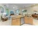 Open-concept kitchen featuring granite countertops, stainless steel appliances, and seamless flow to the living areas at 208 147Th Ne St, Bradenton, FL 34212