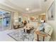 Open concept living room with tile flooring, tray ceiling, and pool view at 208 147Th Ne St, Bradenton, FL 34212