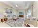 Spacious living room with neutral colors, tile flooring, and tray ceilings at 208 147Th Ne St, Bradenton, FL 34212