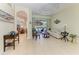 Open living room with tile flooring, stylish furniture, and seamless access to outdoor space at 208 147Th Ne St, Bradenton, FL 34212