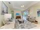 Bright living room with pool view, large painting, and neutral colors at 208 147Th Ne St, Bradenton, FL 34212