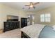 Cozy bedroom with soft carpet, neutral colors, and a view to the backyard pool at 208 147Th Ne St, Bradenton, FL 34212