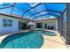 Screened pool with attached spa and surrounding lounge area with tables and chairs at 208 147Th Ne St, Bradenton, FL 34212