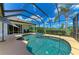 Backyard pool and hot tub inside of a screened enclosure with views of the surrounding landscape at 208 147Th Ne St, Bradenton, FL 34212