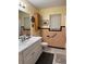 Bathroom featuring a vanity with sink, toilet, and walk-in shower at 2115 Temple St, Sarasota, FL 34239