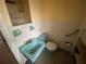 Small bathroom with blue sink, toilet, and tiled walls at 2115 Temple St, Sarasota, FL 34239