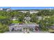 Aerial view of the community featuring lush greenery, a parking lot and building in the distance at 2220 Bahia Vista St # G4, Sarasota, FL 34239
