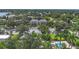 Aerial view of the complex surrounded by mature trees and lush landscaping and shared parking at 2220 Bahia Vista St # G4, Sarasota, FL 34239