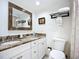 Bathroom with vanity, framed mirror, granite countertops, and shower with curtain at 2220 Bahia Vista St # G4, Sarasota, FL 34239
