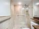Bathroom featuring a tiled shower with glass door and tiled shower seat with grab bars at 2220 Bahia Vista St # G4, Sarasota, FL 34239