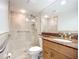 Bathroom featuring a tiled shower with glass door, granite countertop, and modern fixtures at 2220 Bahia Vista St # G4, Sarasota, FL 34239