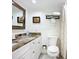 Bathroom with vanity, framed mirror, granite countertops, and shower with curtain at 2220 Bahia Vista St # G4, Sarasota, FL 34239