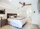 Bedroom featuring a ceiling fan, tiled flooring, and a large bed with dark furniture at 2220 Bahia Vista St # G4, Sarasota, FL 34239