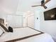Bedroom featuring a ceiling fan, tv, and walk-in closets at 2220 Bahia Vista St # G4, Sarasota, FL 34239