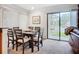 Bright dining room with table for six and adjacent glass doors leading to outdoor views at 2220 Bahia Vista St # G4, Sarasota, FL 34239