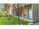 Exterior view of building featuring a porch with a table and palm trees in the front yard at 2220 Bahia Vista St # G4, Sarasota, FL 34239