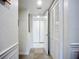 Bright hallway featuring tile floors, white walls, and closet with louvered doors for ample storage space at 2220 Bahia Vista St # G4, Sarasota, FL 34239