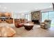 Cozy living room featuring a stone fireplace, modern furniture, and seamless flow to the kitchen at 2220 Bahia Vista St # G4, Sarasota, FL 34239