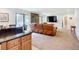 A living room with a leather couch, fireplace, and neutral decor throughout and easy access to the outside at 2220 Bahia Vista St # G4, Sarasota, FL 34239