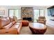 Comfortable living room with fireplace and large windows providing natural light at 2220 Bahia Vista St # G4, Sarasota, FL 34239