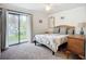 Main bedroom with neutral decor, sliding glass door access to the outside, and en-suite bathroom at 2220 Bahia Vista St # G4, Sarasota, FL 34239