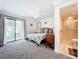 Main bedroom with neutral decor, sliding glass door access to the outside, and en-suite bathroom at 2220 Bahia Vista St # G4, Sarasota, FL 34239