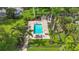 Enjoy the community pool, a serene oasis surrounded by palm trees and landscaped grounds at 2220 Bahia Vista St # G4, Sarasota, FL 34239