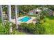 Community pool surrounded by green lawns and palm trees providing a relaxing retreat at 2220 Bahia Vista St # G4, Sarasota, FL 34239