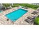 Backyard view showcases a private pool surrounded by lounge chairs and greenery, offering a relaxing outdoor oasis at 2220 Bahia Vista St # G4, Sarasota, FL 34239