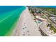 Expansive beachfront view showcasing pristine white sands, turquoise waters, and nearby residential buildings at 2513 Avenue B # B, Bradenton Beach, FL 34217