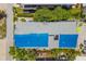 Aerial view of a quaint one-story home showcasing its roof and surrounding lush green landscape at 2513 Avenue B # B, Bradenton Beach, FL 34217