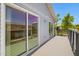 Spacious outdoor balcony featuring durable composite decking, and sliding glass door access to the home at 2513 Avenue B # B, Bradenton Beach, FL 34217