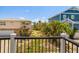Balcony view overlooking lush yard and neighboring coastal homes offering tranquil outdoor living at 2513 Avenue B # B, Bradenton Beach, FL 34217