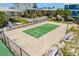 Aerial view of well-maintained basketball court surrounded by native Florida landscaping and nearby homes at 2513 Avenue B # B, Bradenton Beach, FL 34217