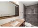 Updated bathroom featuring a granite countertop, large mirror and gray tiled shower with a shower niche at 2513 Avenue B # B, Bradenton Beach, FL 34217