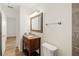 Bright bathroom with updated vanity, wood-look floors, and updated fixtures at 2513 Avenue B # B, Bradenton Beach, FL 34217