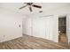 Bedroom featuring wood-look floors, a ceiling fan, closet and access to an updated bathroom at 2513 Avenue B # B, Bradenton Beach, FL 34217