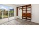 Bedroom featuring updated floors, built-in closet organizer, and sliding door to outside deck at 2513 Avenue B # B, Bradenton Beach, FL 34217