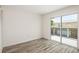 Bedroom with slider to outside deck featuring wood-look flooring at 2513 Avenue B # B, Bradenton Beach, FL 34217