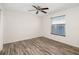 Bright bedroom featuring wood-look floors, a ceiling fan and natural light from the window at 2513 Avenue B # B, Bradenton Beach, FL 34217