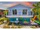 Exterior view of blue beach house with porch at 2513 Avenue B # B, Bradenton Beach, FL 34217