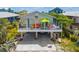 Charming beach house on stilts featuring a vibrant, decorated porch and convenient ground-level parking at 2513 Avenue B # B, Bradenton Beach, FL 34217