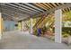 Spacious ground-level garage and storage area with stairs leading to the main living area at 2513 Avenue B # B, Bradenton Beach, FL 34217