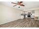 Bright living room and kitchen featuring wood-look floors, stainless steel appliances, and modern fixtures at 2513 Avenue B # B, Bradenton Beach, FL 34217