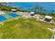 Aerial view of the community park featuring tennis courts, picnic shelters, and a waterfront view at 2513 Avenue B # B, Bradenton Beach, FL 34217